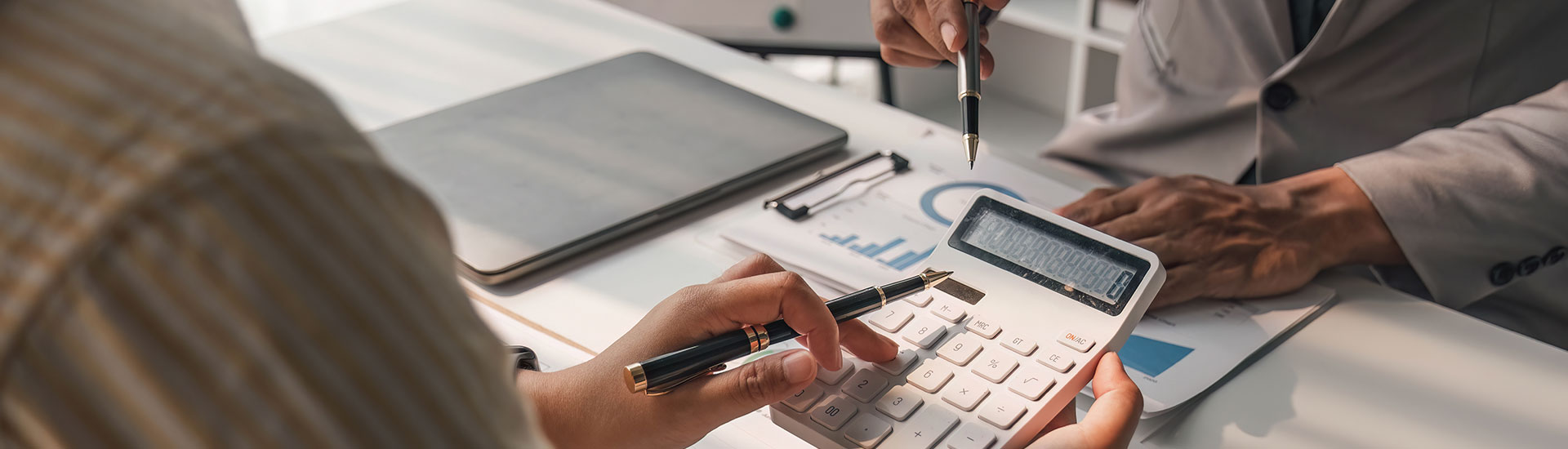 Advisor reviewing financial reports and forecasts with a client